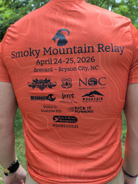 Orange shirt with 'Smoky Mountain Relay' event details and sponsor logos on a person outdoors.