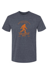 Blue t-shirt with orange SMR Bigfoot graphic of a person and text on a white background
