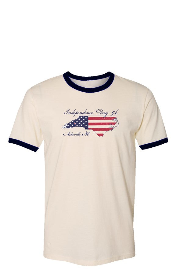 Cream t-shirt with blue cuffs and collar featuring an outline of north Carolina filled with parts of the American flag. The graphic is surrounded by 'Independence Day 5k' and 'Asheville, NC' in ornate text