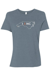 blue t-shirt with white North Carolina outline graphic surrounding 'I RUN NC' text with the word 'RUN' replaced by a silhouetted female runner in orange