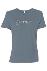 blue t-shirt with white Tennessee outline graphic surrounding 'I RUN TN text with the word 'RUN' replaced by a silhouetted female runner in orange