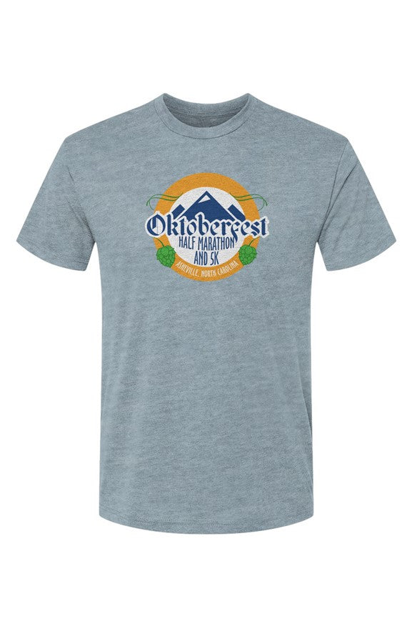 light blue t-shirt with Oktoberfest Half Marathon & 5k logo with blue mountains, green hops in a gold ring on a white background