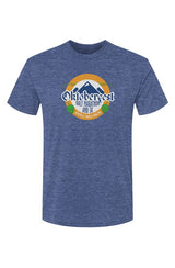 royal blue t-shirt with Oktoberfest Half Marathon & 5k logo with blue mountains, green hops in a gold ring on a white background