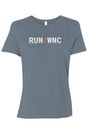 light blue shirt with words RUN / WNC in white with orange slash separating the words