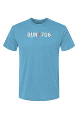 blue t-shirt with words RUN / 706 in white with orange slash separating the words
