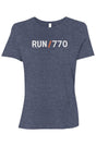 heather blue t-shirt with words RUN / 770 in white with orange slash separating the words