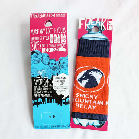 Image of water bottle with orange and blue knitted design featuring SMR ram logo and text, in it's packaging on a white background