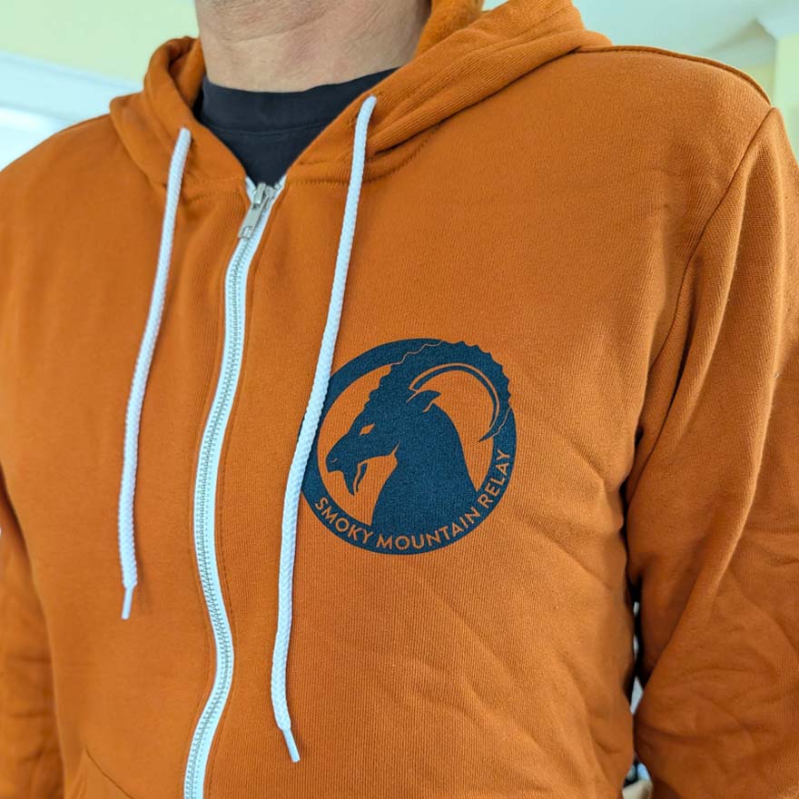 Orange hoodie with a blue SMR ram logo on the chest