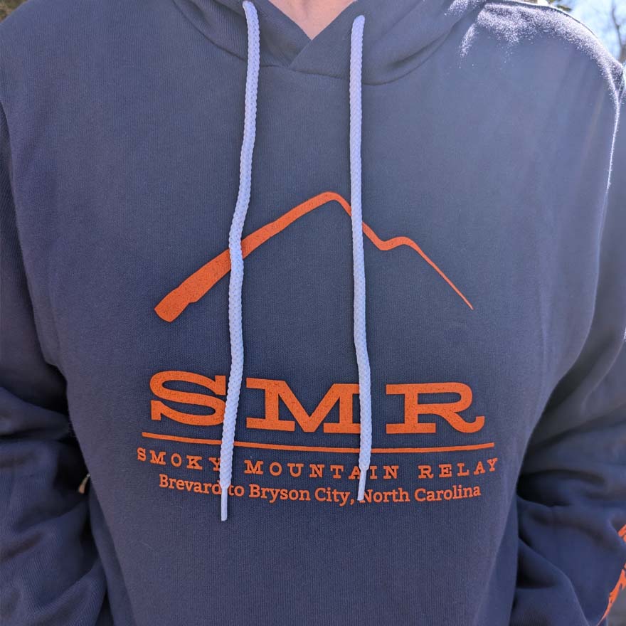 Blue hoodie with orange 'SMR' logo and text, worn by a person.