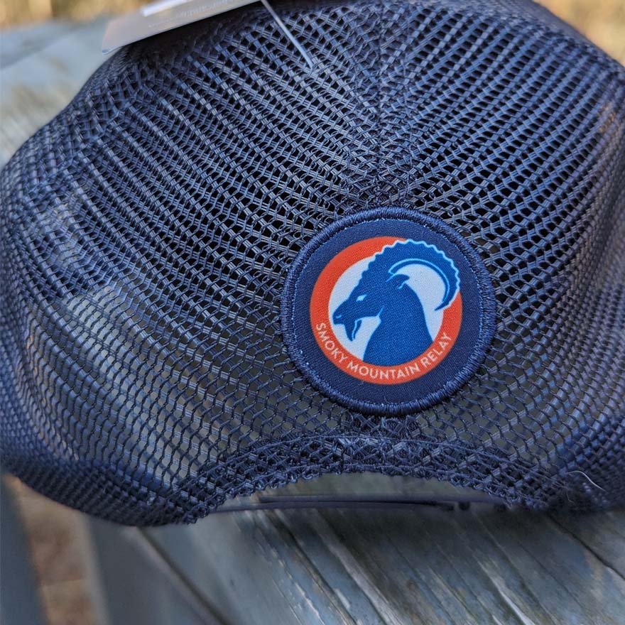 Blue mesh cap with a Smoky mountain Relay ram logo patch on a blurred background