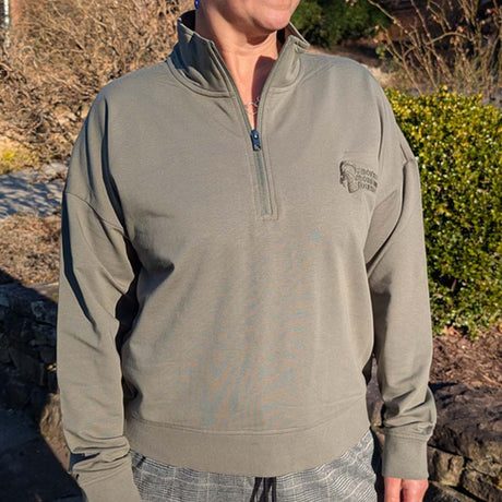 Person wearing a green pullover with a SMR speed ram logo in an outdoor setting