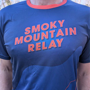 Blue t-shirt with 'Smoky Mountain Relay' text in orange on a person wearing it.